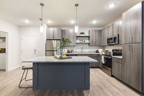 Bradenton apartment for rent - kitchen with granite topped island and modern cabinetry at Residences at The Green in Florida