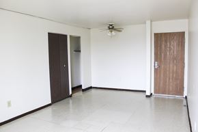 Milwaukee apartment for rent - A room with a ceiling fan and three doors.