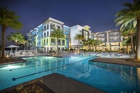 Bradenton apartment for rent - Luxury, resort-style, olympic-sized pool at night at Residences at The Green Apartments for rent