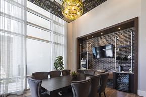 Bradenton apartment for rent - Wine tasting room with wine chandelier, tv, and table with chairs at Residences at The Green in Lakewood Ranch, FL