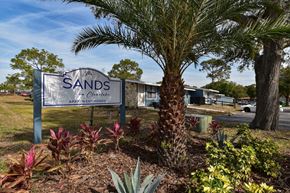 Cocoa apartment for rent - The monument sign for The Sands on Clearlake surrounded by lush landscaping and palm trees