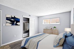 Sarasota apartment for rent - A bedroom with a bed, nightstand, and a painting on the wall.
