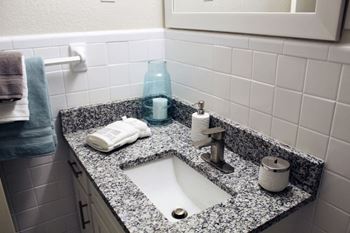 A bathroom with a sink and a mirror