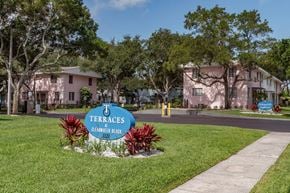 Clearwater apartment for rent - Monument signs with tropical plants, mature trees, and well-kept apartment buildings at Terraces at Clearwater Beach, Florida, 33756