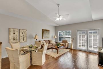 Daphne apartment for rent - A well-lit living room with a glass table and chairs.