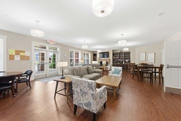 Huntsville apartment for rent - A spacious living room with a variety of furniture including a couch, chairs, and a coffee table.