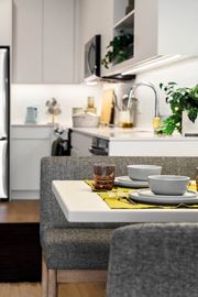 Jersey City apartment for rent - a kitchen with a table with plates and cups on it