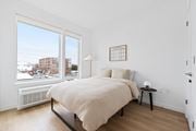 Jersey City apartment for rent - a bedroom with a large window and a bed