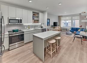 Jersey City apartment for rent - a kitchen and living room with a white counter top