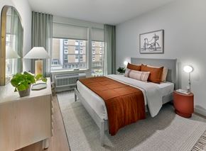 Jersey City apartment for rent - a bedroom with a bed and a large window