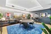 Jersey City apartment for rent - a conference room with a round table and chairs and a blue rug