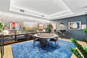 Jersey City apartment for rent - a conference room with a round table and chairs and a blue rug