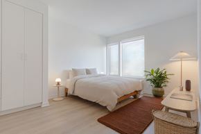 Jersey City apartment for rent - a bedroom with white walls and white bedding