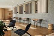 Jersey City apartment for rent - a dining area with tables and chairs and a wall of windows