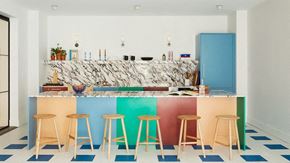 Jersey City apartment for rent - a colorful kitchen with bar stools and a counter with a blue refrigerator