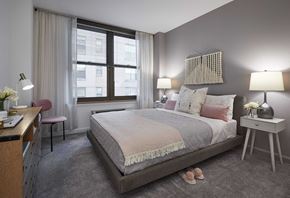 Hoboken apartment for rent - a bedroom with a bed and a desk in a room