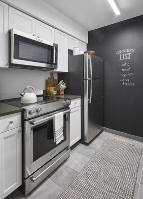 Hoboken apartment for rent - a kitchen with a stove refrigerator and microwave