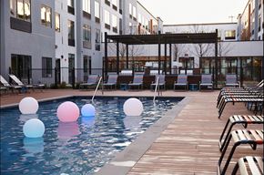 Harrison apartment for rent - A pool with a wooden deck and lounge chairs.