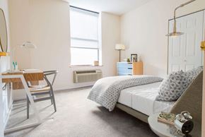 Hoboken apartment for rent - a bedroom with a bed and desk in a 555 waverly unit