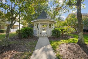 Wilmington apartment for rent - A gazebo is surrounded by trees and bushes.