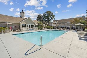 Wilmington apartment for rent - A large swimming pool with a building in the background.