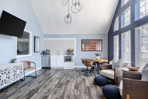 Warner Robins apartment for rent - A modern kitchen with a wooden floor and a dining table with chairs.