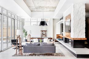 Denver apartment for rent - A modern living room with a grey couch and a wooden coffee table.