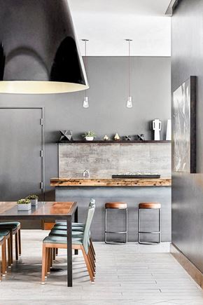 Denver apartment for rent - A modern kitchen with a wooden table and chairs.