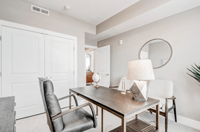 Sandy apartment for rent - A modern dining room with a wooden table and leather chairs.