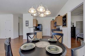 Greensboro apartment for rent - A modern dining room with a black table and chairs at Ethan Pointe Apartments, North Carolina, 27215