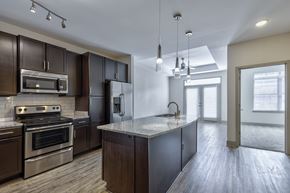 Knoxville apartment for rent - A modern kitchen with dark wood cabinets and stainless steel appliances.