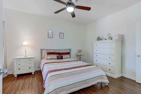 Greensboro apartment for rent - A bedroom with a bed, dresser, and ceiling fan at Ethan Pointe Apartments, North Carolina