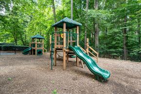 Marietta apartment for rent - A playground with a green slide and a wooden structure.