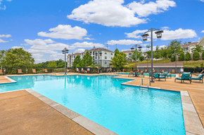 Nashville apartment for rent - A large swimming pool with a blue tinted water and a brownish floor.