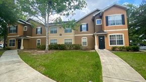Clermont apartment for rent - Building exterior with bushes and trees and  a side walk.