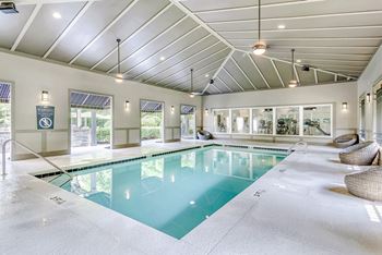 Outdoor and covered swimming pools with sundeck seating and pergola