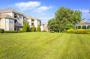 Louisville apartment for rent - a large lawn in front of some apartment buildings