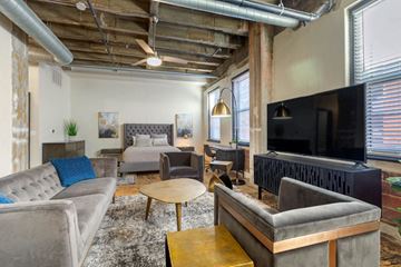 Denver apartment for rent - A living room with a grey couch and a wooden coffee table.