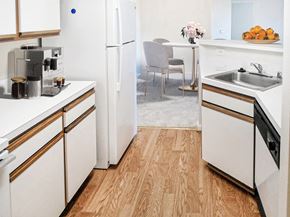 Warrenton apartment for rent - A kitchen with white appliances and wooden floors.
