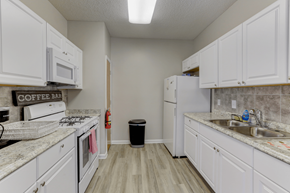 Durham apartment for rent - a kitchen with white cabinets and appliances and a sink