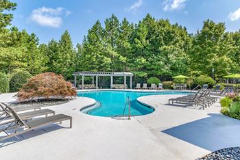 Outdoor and covered swimming pools with sundeck seating and pergola