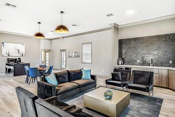 Bradenton apartment for rent - A modern living room with a black couch and a coffee table.