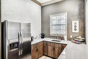 Bradenton apartment for rent - Clubhouse kitchen with stainless steel appliances, brown cabinets and coffee supplies on the countertop