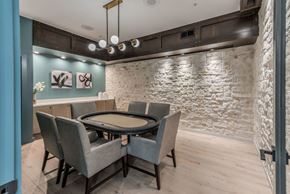 Houston apartment for rent - a dining room with a table and chairs in front of a brick wall