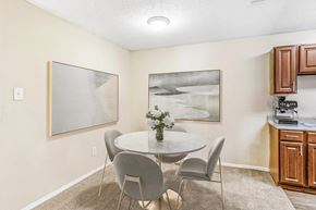 Euless apartment for rent - Dining room with a 4 person table and ceiling light above the table.