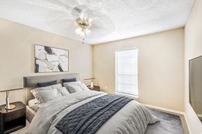 Euless apartment for rent - Bedroom with queen size bed, night stand with lamp and a ceiling fan
