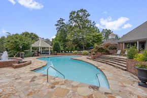 Durham apartment for rent - A pool surrounded by a stone patio and a gazebo.