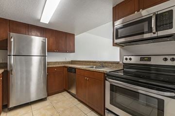 Key West apartment for rent - a kitchen with stainless steel appliances and wooden cabinets