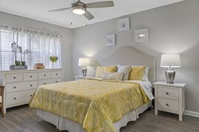 Boca Raton apartment for rent - A bedroom with a bed, nightstands, and a ceiling fan.