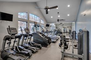Raleigh apartment for rent - A gym with treadmills, elliptical machines, and other exercise equipment.